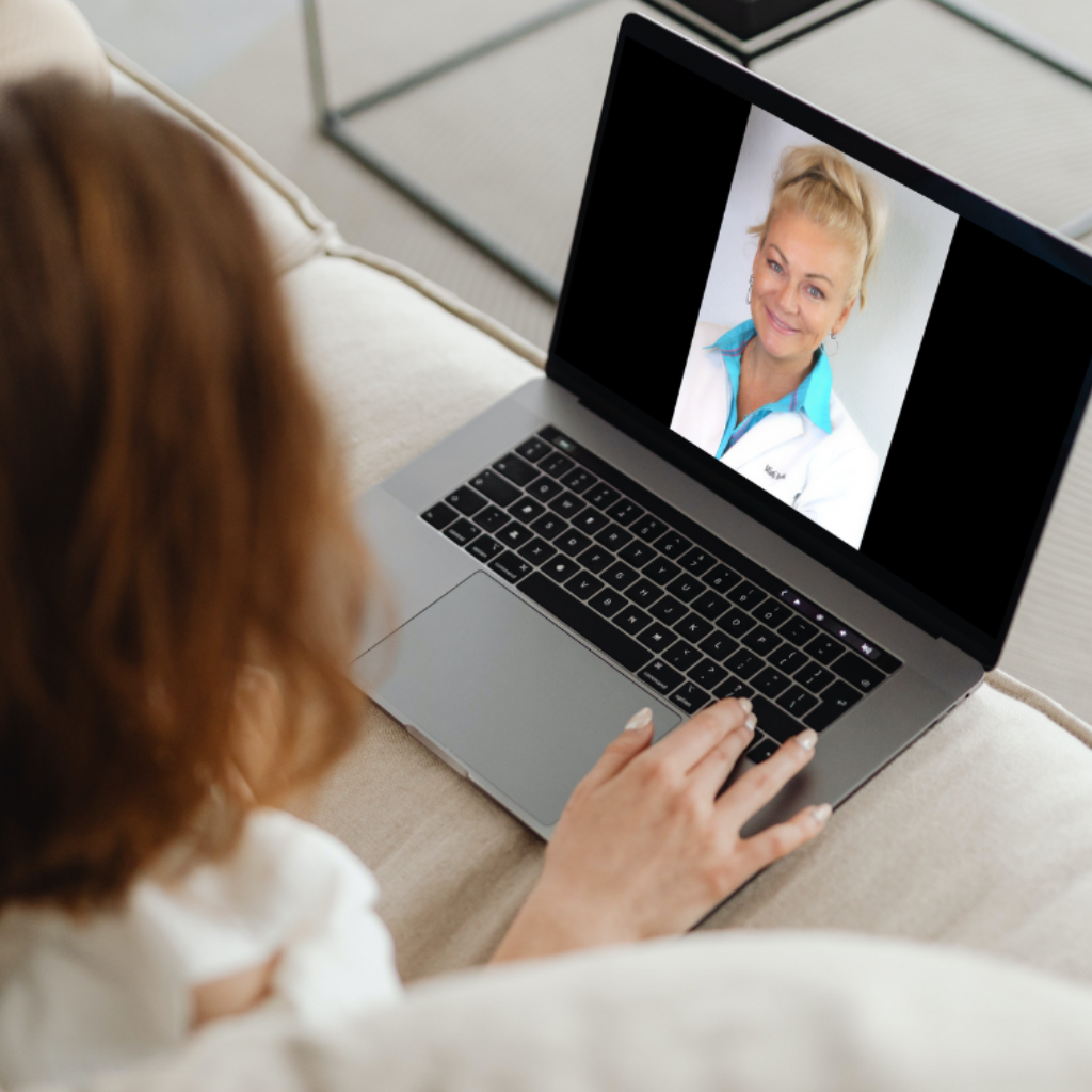 Woman at home on laptop consulting with certified trichologist Misti Barnes about menopause hair loss